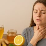 Woman holding her throat with natural home remedies like honey, ginger, lemon, and turmeric for sore throat relief